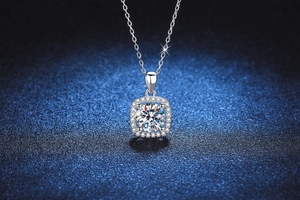 Detailed macro view of 1 carat princess halo moissanite pendant on silver chain