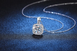 Macro view of a 1-carat square halo moissanite pendant on a fine silver chain