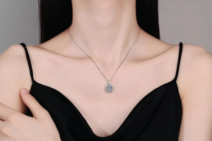 Close-up of a s925 silver square pendant necklace with 1 carat moissanite on a model