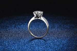 Macro detail of a 1 carat moissanite ring with classic six-prong setting and side accents