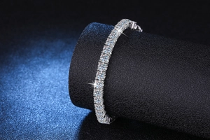 Close-up of S925 sterling silver tennis bracelet featuring Moissanite stones on black stand