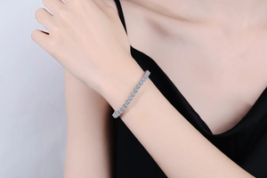 Close-up of a classic S925 sterling silver tennis bracelet with round moissanite stones