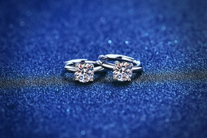 Macro detail of classic four-prong S925 silver stud earrings with moissanite center stones