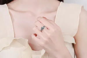 Close-up of three-stone s925 sterling silver ring with 3-carat moissanite on finger