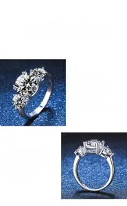 Close-up detail of three-stone moissanite ring with polished sterling silver setting