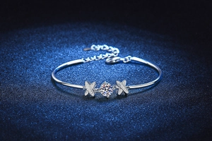Macro detail of S925 silver bow bracelet featuring 1ct moissanite and pavé set accents