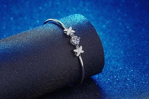 Macro detail of s925 silver bow bracelet featuring 1 carat moissanite and pave stones