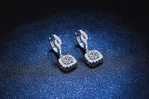 Macro detail of S925 silver halo earrings featuring square pendants with moissanite stones