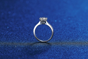 Macro detail of six-prong S925 silver moissanite ring with side accent stones