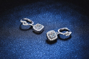 Detailed macro view of S925 silver moissanite earrings with halo set and twisted diamond hoop