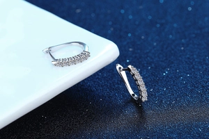 Macro shot of S925 sterling silver hoop earrings with shimmering row diamonds detail