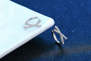 Close-up of S925 silver hoop earrings with crisscross X design and white pavé zircons