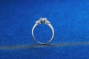 Macro shot of three-stone S925 sterling silver ring with a round Moissanite center stone