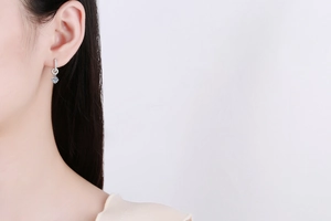 Detailed close-up of a S925 sterling silver drop earring with a brilliant blue moissanite