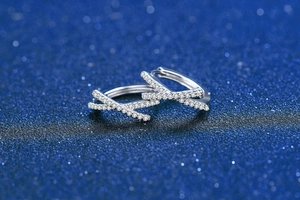 Macro shot of S925 sterling silver bow earrings with micro-paved moissanite stones