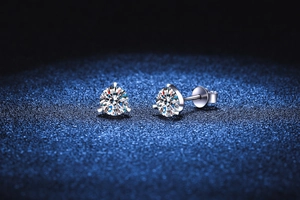 Macro shot of three-prong round cut moissanite stud earrings in S925 sterling silver