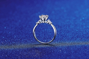 Side view of a 925 silver ring with a 1-carat moissanite and two pear-shaped side stones