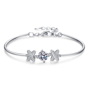 S925 silver bow bracelet with round moissanite and double X accents on white background