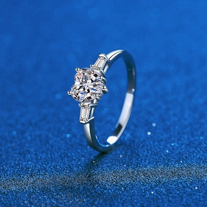 Elegant s925 silver heart shaped moissanite ring with baguette side stones on blue background