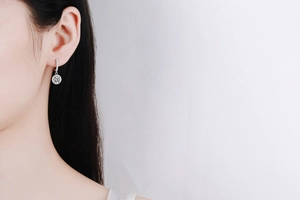 Close-up of sparkling s925 silver moissanite hoop earrings worn on female earlobe