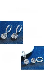 Macro shot of halo design moissanite earrings showing brilliant cut and polished silver setting