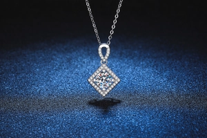 Macro view of geometric square pendant with moissanite center stone and pavé accents