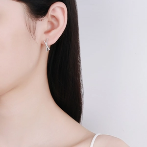 Elegant s925 silver cross-shaped stud earrings with pavé set moissanite stones on model