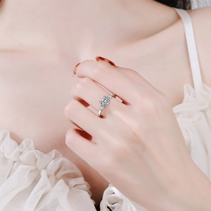 Elegant S925 sterling silver ring with round moissanite stone and side baguettes on finger