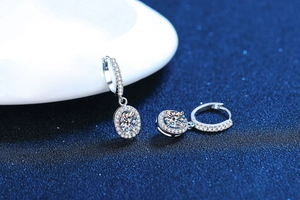 Macro shot of oval moissanite earrings in S925 silver with sparkling diamond accents