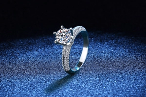 Macro shot of 1-3 carat moissanite ring with six-prong setting and micro-paved band