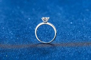 Macro shot of princess cut moissanite ring with pavé diamonds on S925 sterling silver band