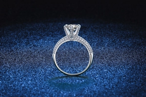 Close-up of a s925 silver moissanite ring with six-prong setting on a starry blue base
