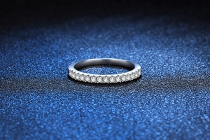 Macro shot of 925 silver moissanite eternity band ring on sparkling blue background
