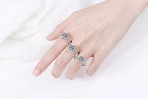 Three stacked s925 silver moissanite rings with six-prong setting and pavé diamonds