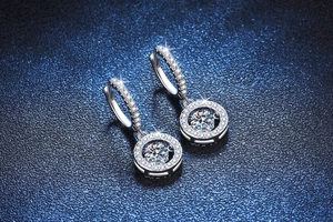 Macro detail of S925 sterling silver dancing moissanite halo huggie earrings