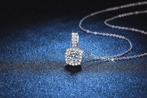 Macro detail of square halo pendant necklace featuring brilliant round cut moissanite
