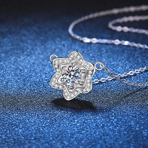 Halskette mit Kamelien-Anhänger aus S925-Silber und 1-Karat-Moissanit auf blauem Hintergrund