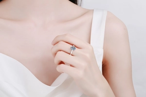 Macro view of a 2-carat Moissanite ring on a finger with classic multi-prong setting