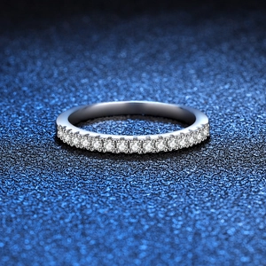 Minimalist S925 sterling silver moissanite row ring featuring a polished finish on blue background