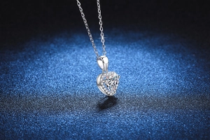 Macro shot of S925 silver heart pendant with 1ct moissanite and halo setting