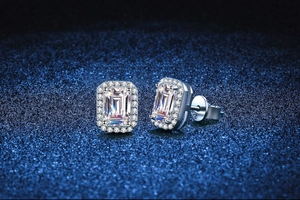 Macro view of S925 sterling silver earring with emerald-cut moissanite and halo setting