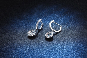 Close-up of S925 sterling silver hoop earrings with round Moissanite pendant details