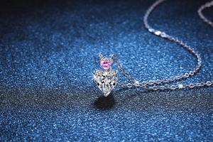 Close-up of S925 silver double heart pendant with pink gemstone and white moissanite