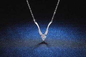 Macro view of teardrop Moissanite pendant with V-shaped diamond micro-pave setting