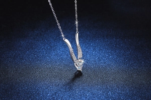 Macro shot of S925 silver Mobius necklace with pear-shaped D-color Moissanite pendant