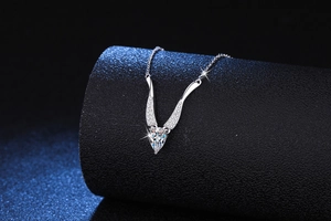 Macro shot of silver Moissanite pear drop pendant with micro-inlaid diamonds