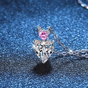 S925 sterling silver necklace featuring two heart-shaped moissanite pendants on dark background