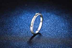 Close-up of S925 sterling silver ring featuring three round moissanite stones on a slim band