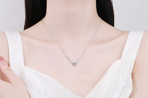 Close-up of s925 silver necklace with pear-cut blue moissanite in V-shape pendant
