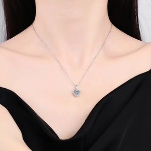 Elegant S925 sterling silver heart-shaped moissanite necklace worn by a model